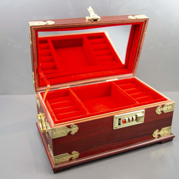 Open Chinese red velvet jewelry box with mirror and compartments Desc 1: Interior view of velvet-lined jewelry box with various storage sections