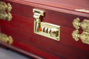 Open Chinese red velvet jewelry box with mirror and compartments Desc 1: Interior view of velvet-lined jewelry box with various storage sections