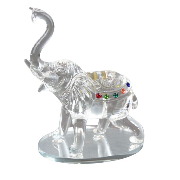 Crystal elephant figurine with colorful jewels and raised trunk on glass base